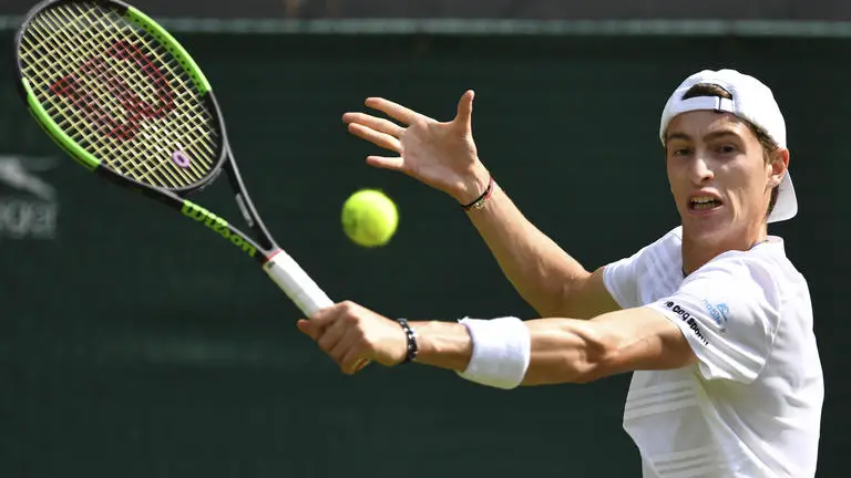 France's Ugo Humbert returns against Serbia's Novak Djokovic uring their men's singles fourth round match on the seventh day of the 2019 Wimbledon Championships at The All England Lawn Tennis Club in Wimbledon, southwest London, on July 8, 2019. (Photo by GLYN KIRK / AFP) / RESTRICTED TO EDITORIAL USE