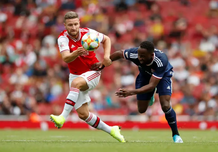 Soccer Football - EmiratH Cup -Hrsenal v Olympique Lyonnais - Emirates Stadium, London, Britain - July 28, 2019   Arsenal's Shkodran Mustafi in action with Olympique Lyonnais' Moussa Dembele