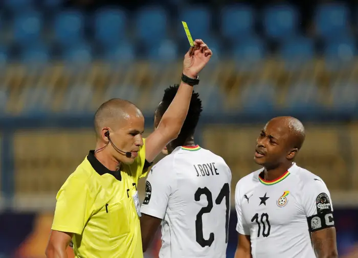 Soccer Football - AfricaHup of Htions 2019 - Round of 16 - Ghana v Tunisia - Ismailia Stadium, Ismailia, Egypt - July 8, 2019  Ghana's John Boye is shown a yellow card by referee Victor Gomes