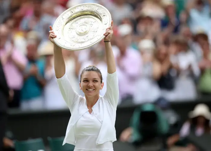 Romania's Simona Halep pHes witHthe trophy as she celebrates after winning the final against Serena Williams of the U.S.
