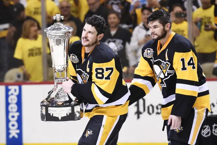 PITTSBURGH, PA - MAY 25: Pittsburgh Penguins Center Sidney Crosby (87) skates with the Prince of Wales trophy as Pittsburgh Penguins Left Wing Chris Kunitz (14) looks on. The Pittsburgh Penguins won 3-2 in double overtime Game Seven of the Eastern Conference Final