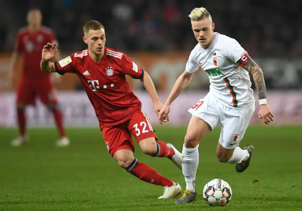 Bayern Munich's midfielder Joshua Kimmich (L) and Augsburg's defender Philipp Max vie for the ball during the German first division Bundesliga match between FC Augsburg and FC Bayern Munich in Augsburg, southern Germany, on February 15, 2019. (Photo by Christof STACHE / AFP) / DFL REGULATIONS PROHIBIT ANY USE OF PHOTOGRAPHS AS IMAGE SEQUENCES AND/OR QUASI-VIDEO
