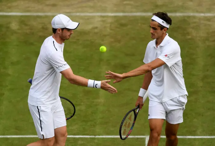 Tennis - Wimbledon - All England Lawn Tennis and Croquet Club, London, Britain - July 4, 2019  Britain's Andy Murray and France's Pierre-Hugues Herbert during their first round double's match against Romania's Marius Copil and France's Ugo Humbert
