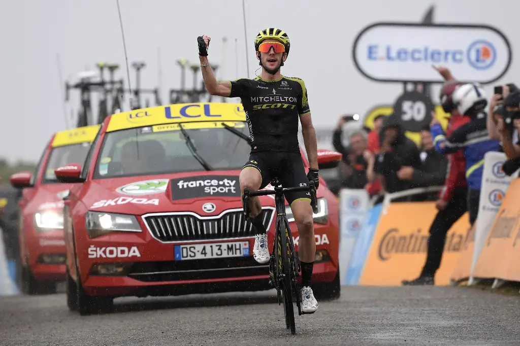 Great Britain's Simon Yates celebrates as he wins on the finish line of the fifteen stage of the 106th edition of the Tour de France cycling race between Limoux and Foix Prat d'Albis, in Foix Prat d'Albis on July 21, 2019. (Photo by JEFF PACHOUD / AFP)