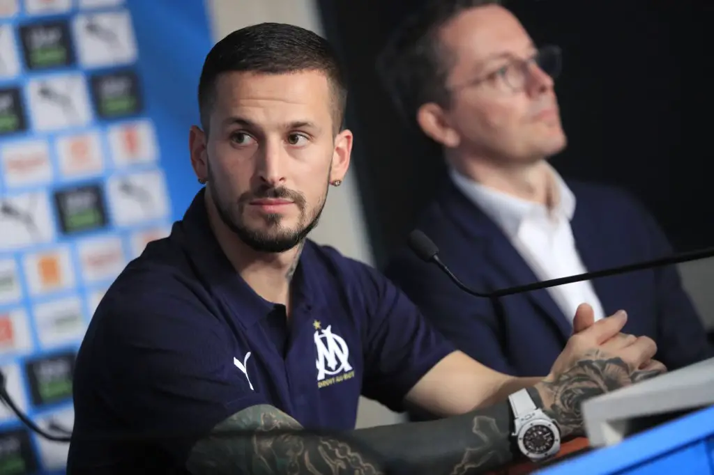 French L1 football club Olympique de Marseille's (OM) newly recruited Argentina forward Dario Benedetto (L) looks on next to the club's president Jacques-Henri Eyraud (R), during his official presentation to the press in Marseille on August 5, 2019. - Benedetto, 29, from Boca Juniors signed a four-year deal. He has made five international appearances since his debut in 2017, and has reportedly cost the French club 16 million euros ($17.9 million). (Photo by - / AFP)