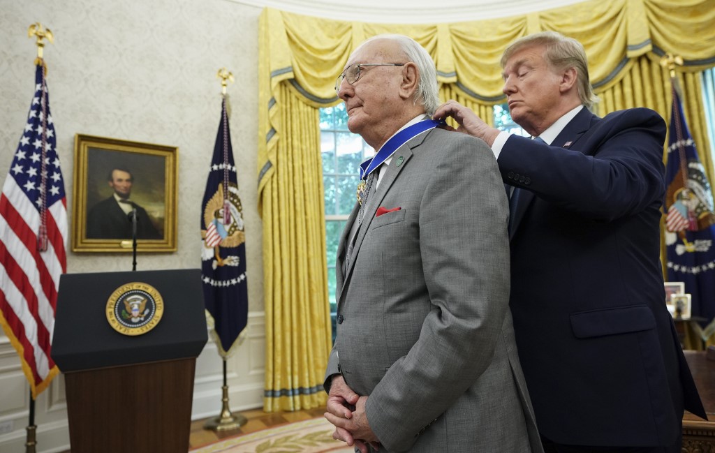 US President Donald Trump presents the Presidential Medal of Freedom to Celtics basketball legend Bob Cousy in the Oval Office of the White House in Washington, DC on August 22, 2019. (Photo by MANDEL NGAN / AFP)