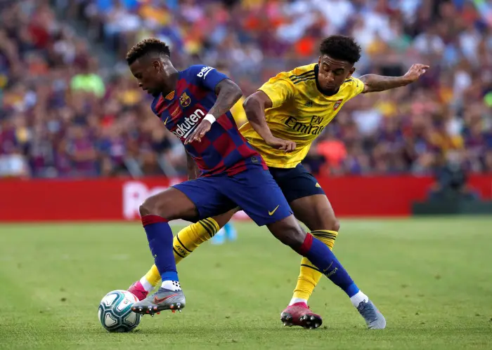 Barcelona's Nelson SemeH in acHon with Arsenal's Reiss Nelson