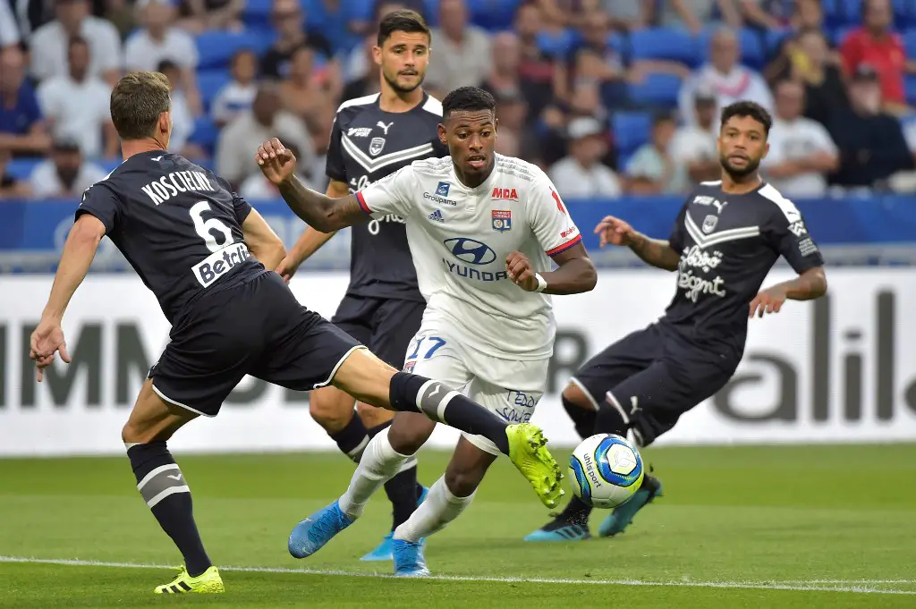 Lyon's French midfielder Jeff Reine-Adelaide (C) vies with Bordeaux's players during the French L1 football match between Lyon (OL) and Bordeaux (FCB) on August 31, 2019, in Decines-Charpieu, near Lyon, central-eastern France. (Photo by ROMAIN LAFABREGUE / AFP)