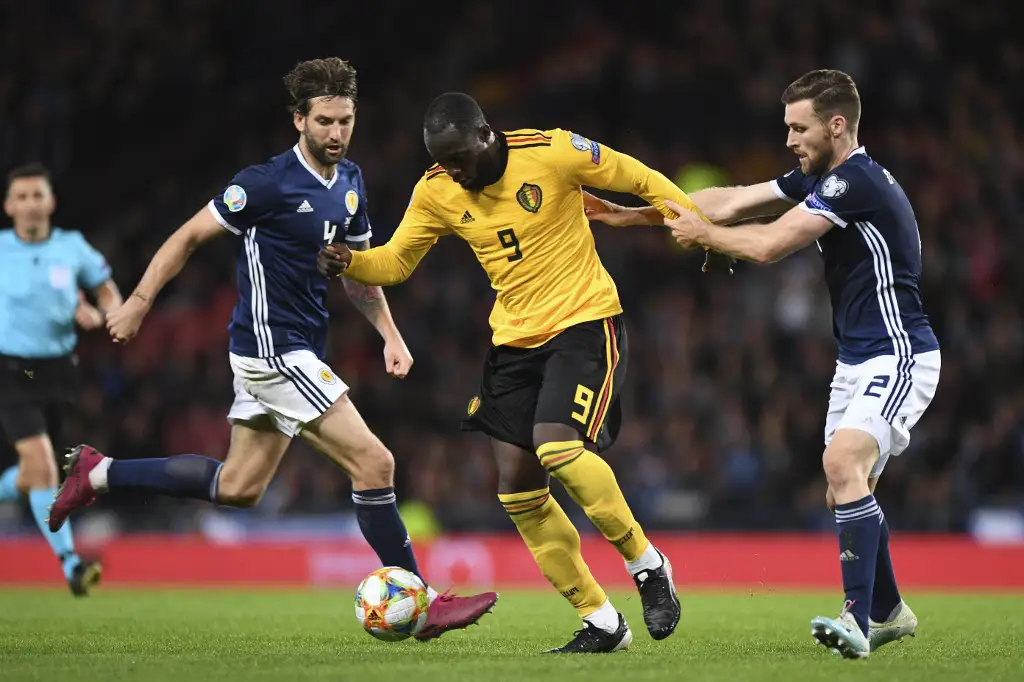 Belgium's striker Romelu Lukaku (C) is tackled by Scotland's defender Stephen O'Donnell (R) during the Euro 2020 football qualification match between Scotland and Belgium at Hampden Park, Glasgow on September 9, 2019. (Photo by ANDY BUCHANAN / AFP)