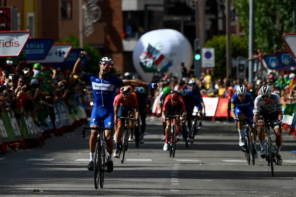 Team Deceuninck rider Belgium's Philippe Gilbert (L) celebrates as he crosses the finish line and wins the 17th stage of the 2019 La Vuelta cycling Tour of Spain, a 219,6 km race from Aranda de Duero to Guadalajara on September 11, 2019. (Photo by OSCAR DEL POZO / AFP)