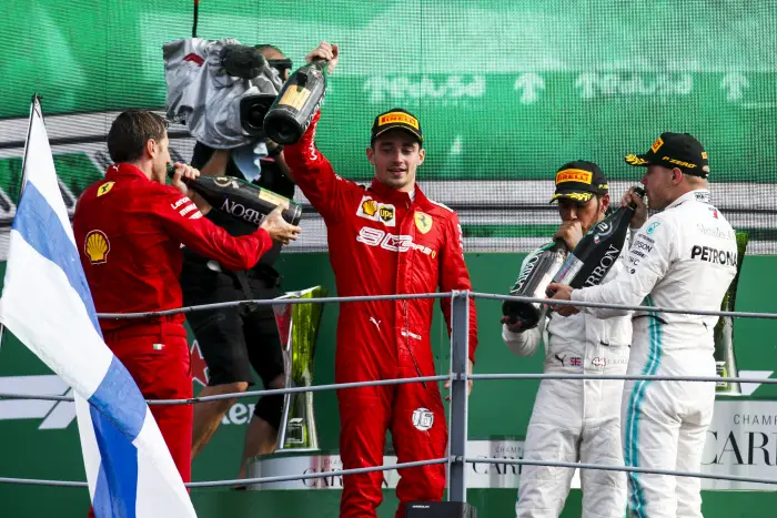 AUTODROMO NAZIONALE MONZA, ITALY - SEPTEMBER 08: Charles Leclerc, Ferrari, 1st position, Lewis Hamilton, Mercedes AMG F1, 3rd position, and Valtteri Bottas, Mercedes AMG F1, 2nd position, celebrate on the podium during the Italian GP at Autodromo Nazionale Monza on September 08, 2019 in Autodromo Nazionale Monza, Italy