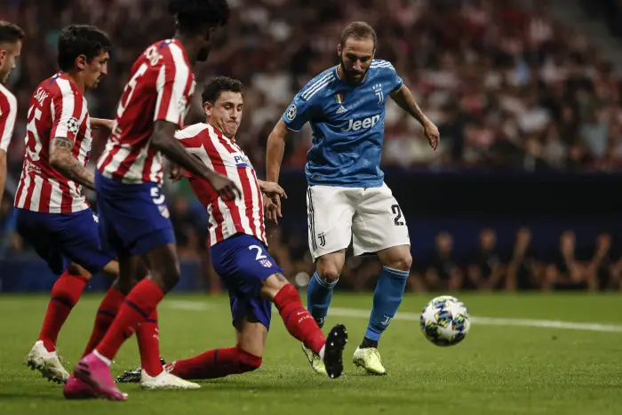 Jose Maria Gimenez (Atletico de Madrid) challenges for control of the ball with Gonzalo Higuain (Juventus),   UCL Champions League match between Atletico de Madrid vs Juventus at the Wanda Metropolitano stadium in Madrid, Spain, September 18, 2019 .