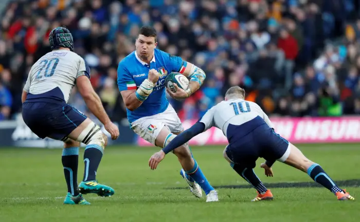 Italy's Sebastian Negri in action with Scotland's Josh Strauss and Finn Russell