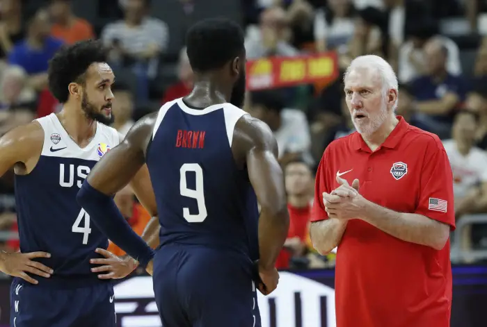 Coach of the U.S. GreggHopovicHspeaks with Derrick White and Jaylen Brown during the match