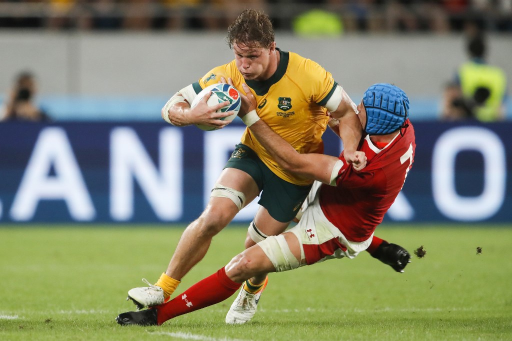 Australia's flanker Michael Hooper (L) is tackled by Wales' flanker Justin Tipuric  during the Japan 2019 Rugby World Cup Pool D match between Australia and Wales at the Tokyo Stadium in Tokyo on September 29, 2019. (Photo by Odd ANDERSEN / AFP)