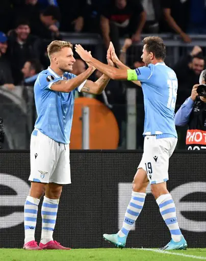 Lazio's Italian forward Ciro Immobile (L) celebrates with teammates after scoring a goal during the UEFA Europa League Group E football match between Lazio Rome and Stade Rennais FC on October 3, 2019 at the Olympic stadium in Rome. (Photo by Tiziana FABI / AFP)