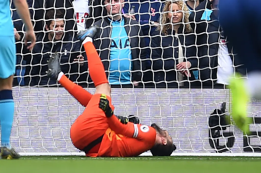 Tottenham Hotspur's French goalkeeper Hugo Lloris lies injured after Brighton's French striker Neal Maupay scores his team's first goal during the English Premier League football match between Brighton and Tottenham Hotspur at the American Express Community Stadium in Brighton, southern England on October 5, 2019. (Photo by Glyn KIRK / AFP) / RESTRICTED TO EDITORIAL USE. No use with unauthorized audio, video, data, fixture lists, club/league logos or 'live' services. Online in-match use limited to 120 images. An additional 40 images may be used in extra time. No video emulation. Social media in-match use limited to 120 images. An additional 40 images may be used in extra time. No use in betting publications, games or single club/league/player publications. /