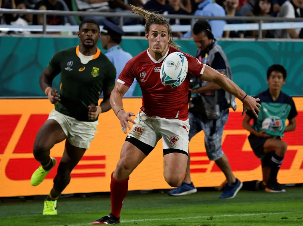 Canada's wing Jeff Hassler (R) runs for the ball  during the Japan 2019 Rugby World Cup Pool B match between South Africa and Canada at the Kobe Misaki Stadium in Kobe on October 8, 2019. (Photo by Filippo MONTEFORTE / AFP)