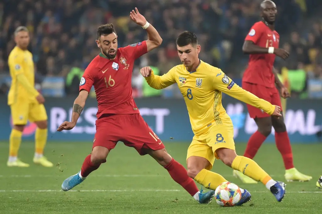 Portugal's midfielder Bruno Fernandes and Ukraine's midfielder Ruslan Malinovskyi vie for the ball during the Euro 2020 football qualification match between Ukraine and Portugal at the NSK Olimpiyskyi stadium in Kiev on October 14, 2019. (Photo by Genya SAVILOV / AFP)