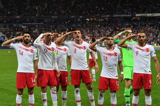 Turkish players salute at the end of the Euro 2020 Group H qualification football match between France and Turkey at the Stade de France in Saint-Denis, outside Paris on October 14, 2019. (Photo by Alain JOCARD / AFP)