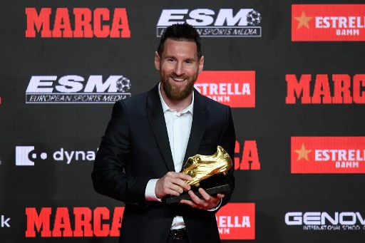 Barcelona's Argentinian forward Lionel Messi poses with his sixth Golden Shoe awards after receiving the 2019 European Golden Shoe honoring the year's leading goalscorer during a ceremony at the Antigua Fabrica Estrella Damm in Barcelona on October 16, 2019. (Photo by Josep LAGO / AFP)