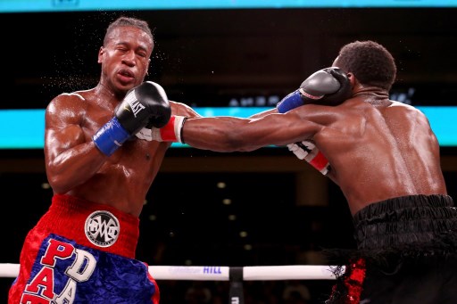 (FILES) In this file photo taken on October 12, 2019 Patrick Day (L) and Charles Conwell exchange punches in the seventh round of their Super-Weltereight bout at Wintrust Arena in Chicago, Illinois. - American boxer Patrick Day died October 16, 2019, after suffering a serious brain injury during his knockout defeat to Charles Conwell last weekend, promoter Lou DiBella said in a statement. (Photo by Dylan Buell / GETTY IMAGES NORTH AMERICA / AFP)
