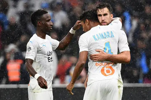 Marseille's Dutch midfielder Kevin Strootman (R) celebrates scoring his team's second goal during the French L1 football match between Olympique de Marseille (OM) and Racing Club de Strasbourg Alsace (RCS) on October 20, 2019, at the Velodrome Stadium in Marseille, southern France. (Photo by Boris HORVAT / AFP)