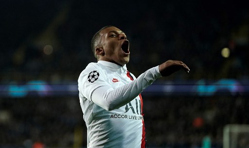 Paris Saint-Germain's French forward Kylian Mbappe celebrates scoring his team's fifth goal during the UEFA Champions League Group A football match between Brugge and Paris Saint-Germain's (PSG)  on October 22, 2019 at the Jan Breydel stadium in Bruges. (Photo by Kenzo TRIBOUILLARD / AFP)