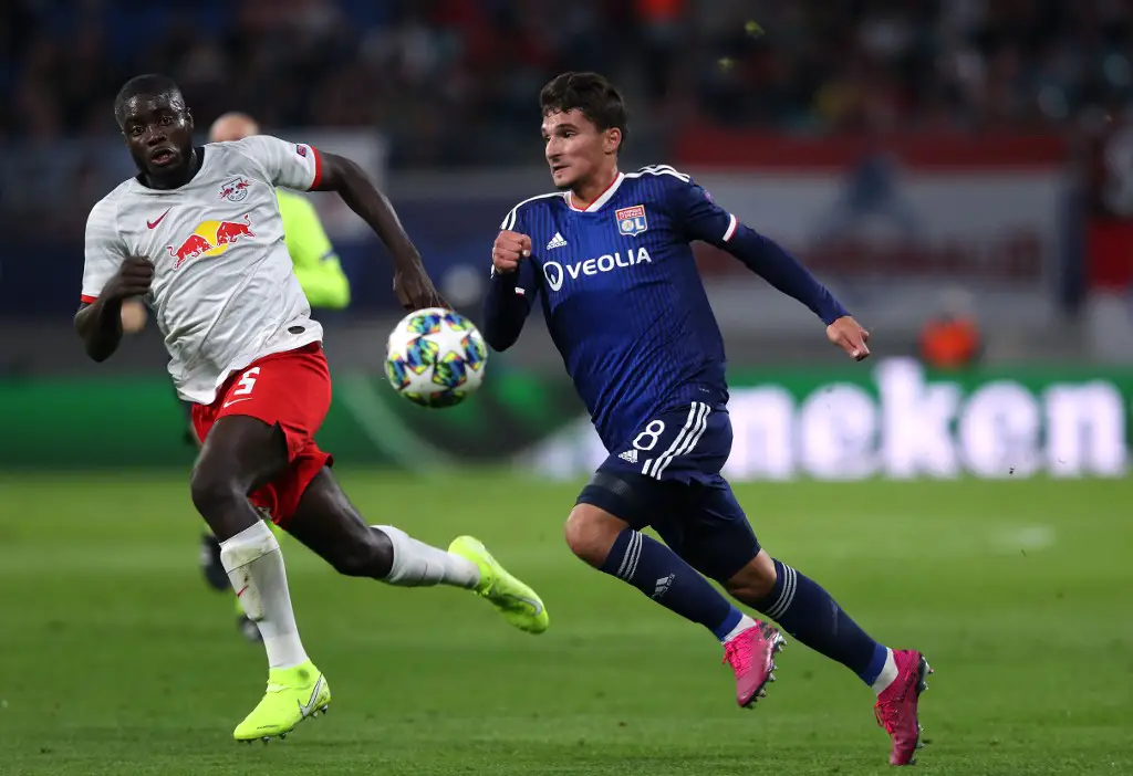 Leipzig's French defender Dayot Upamecano (L) and Lyon's French midfielder Houssem Aouar vie for the ball during the UEFA Champions League Group G football match RB Leipzig v Olympique Lyonnais (OL) in Leipzig, eastern Germany, on October 2, 2019. (Photo by Ronny Hartmann / AFP)