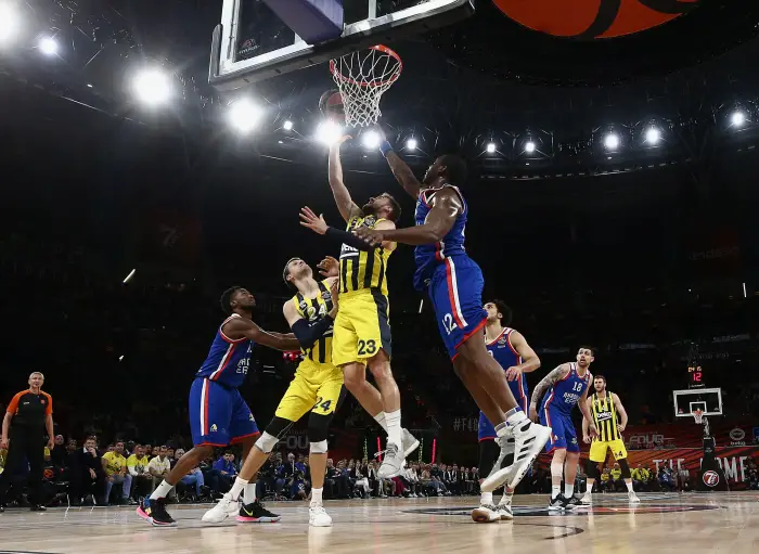 VITORIA-GASTEIZ, SPAIN - MAY 17, 2019: Fenerbahce Istanbul's Jan Vesely, Marko Guduric, and Anadolu Efes' Bryant Dunston (L-R centre) in action in the 2019 Euroleague Final Four semi-final basketball match between Fenerbahce Beko and Anadolu Efes at Fernando Buesa Arena.