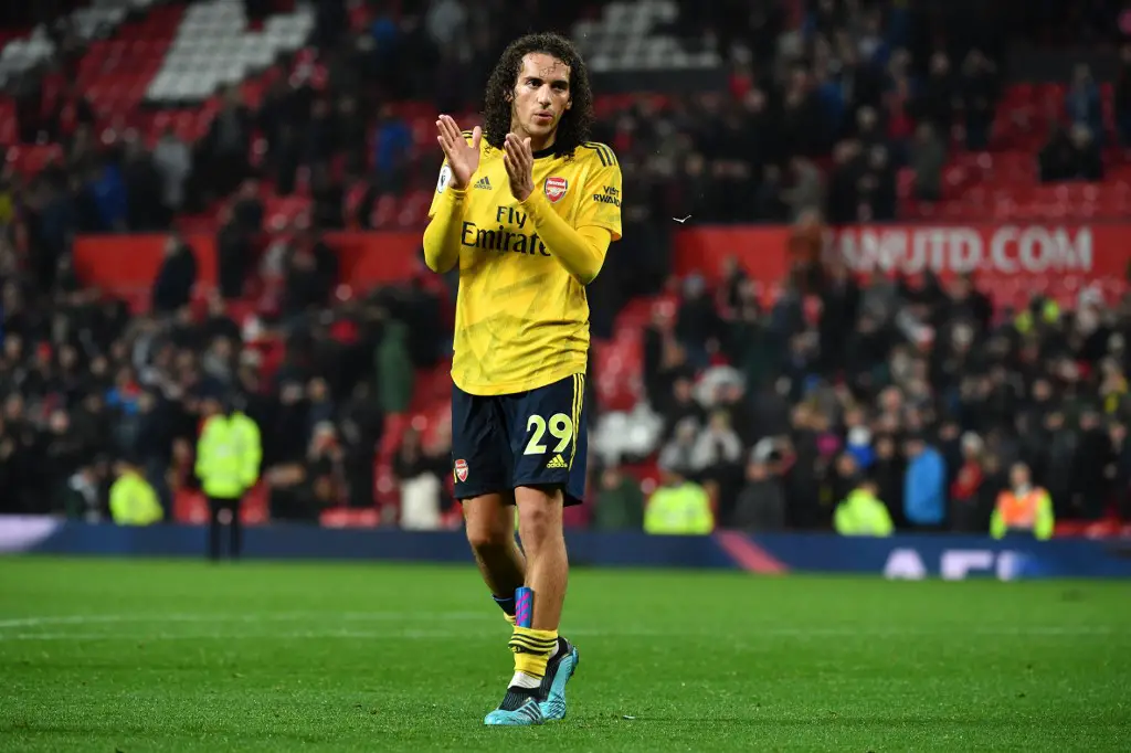 Arsenal's French midfielder Matteo Guendouzi applauds supporters on the pitch after the English Premier League football match between Manchester United and Arsenal at Old Trafford in Manchester, north west England, on September 30, 2019. - The game finished 1-1. (Photo by Paul ELLIS / AFP) / RESTRICTED TO EDITORIAL USE. No use with unauthorized audio, video, data, fixture lists, club/league logos or 'live' services. Online in-match use limited to 120 images. An additional 40 images may be used in extra time. No video emulation. Social media in-match use limited to 120 images. An additional 40 images may be used in extra time. No use in betting publications, games or single club/league/player publications. /