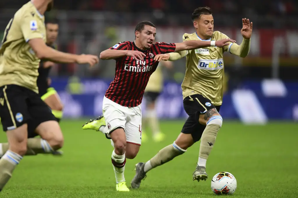 AC Milan's Algerian defender Ismael Bennacer (C) fights for the ball with Spal's Italian forward Alessandro Murgia during the Italian Serie A football match AC Milan vs Spal on October 31, 2019 at the San Siro stadium in Milan. (Photo by MIGUEL MEDINA / AFP)