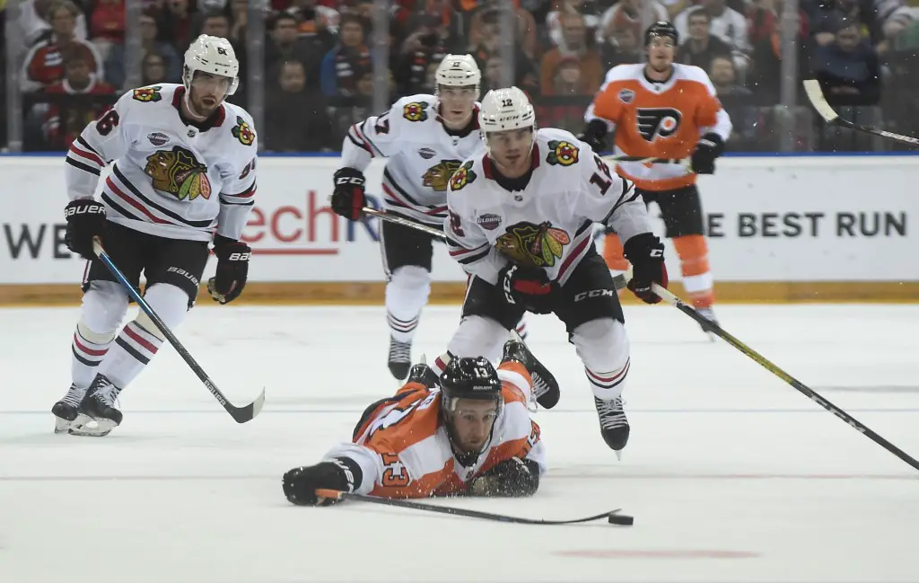Kevin Hayes of the Philadelphia Flyers (front) vies for the puck with Alex DeBrincat of Chicago Blackhawks during the NHL Global Series Ice Hockey match Philadelphia Flyers v Chicago Blackhawks in Prague on October 4, 2019. (Photo by Michal CIZEK / AFP)