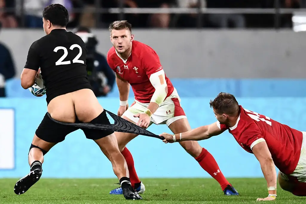 EDITORS NOTE: Graphic content / New Zealand's centre Anton Lienert-Brown (L) has his shorts pulled by Wales' wing Hallam Amos (R) during the Japan 2019 Rugby World Cup bronze final match between New Zealand and Wales at the Tokyo Stadium in Tokyo on November 1, 2019. (Photo by Anne-Christine POUJOULAT / AFP)