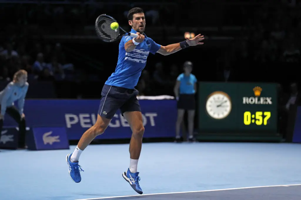 Serbia's Novak Djokovic returns against Italy's Matteo Berrettini during their men's singles round-robin match on day one of the ATP World Tour Finals tennis tournament at the O2 Arena in London on November 10, 2019. (Photo by Adrian DENNIS / AFP)