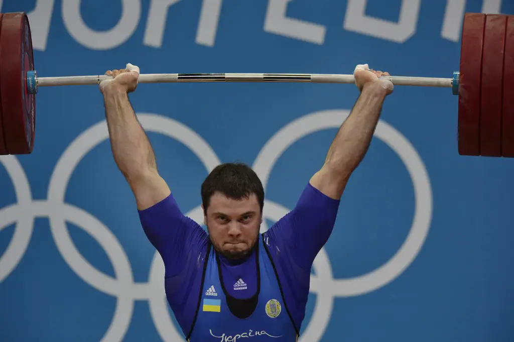 Ukrania's Oleksiy Torokhtiy competes to win the gold medal during the men's 105kg group A weightlifting event of the London 2012 Olympic Games at The Excel Centre in London on August 6, 2012. AFP PHOTO / YURI CORTEZ (Photo by YURI CORTEZ / AFP)