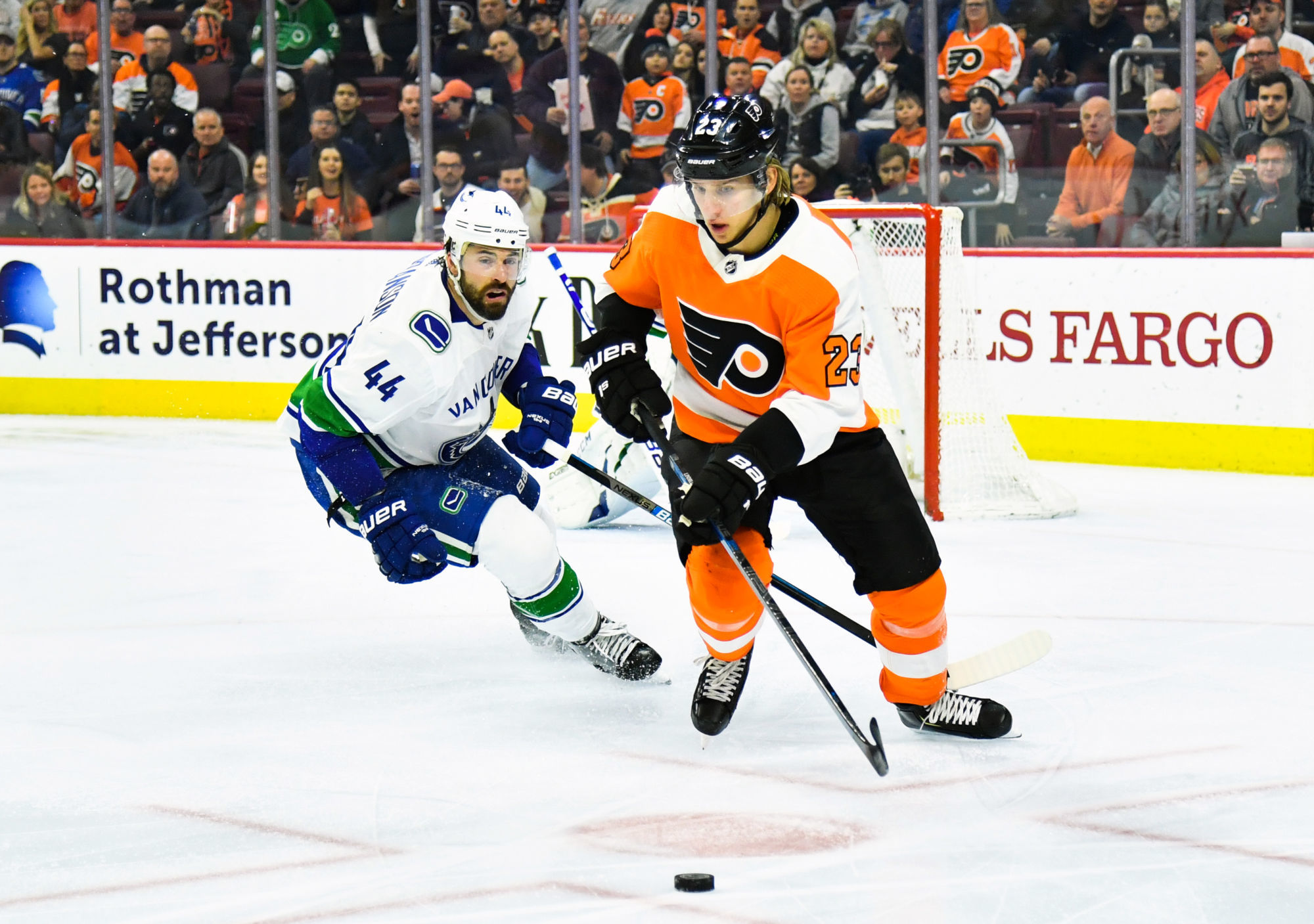 Feb 4, 2019; Philadelphia, PA, USA; Philadelphia Flyers left wing Oskar Lindblom (23) and Vancouver Canucks defenseman Erik Gudbranson (44) battle for the puck during the second period at Wells Fargo Center. Photo : SUSA / Icon Sport