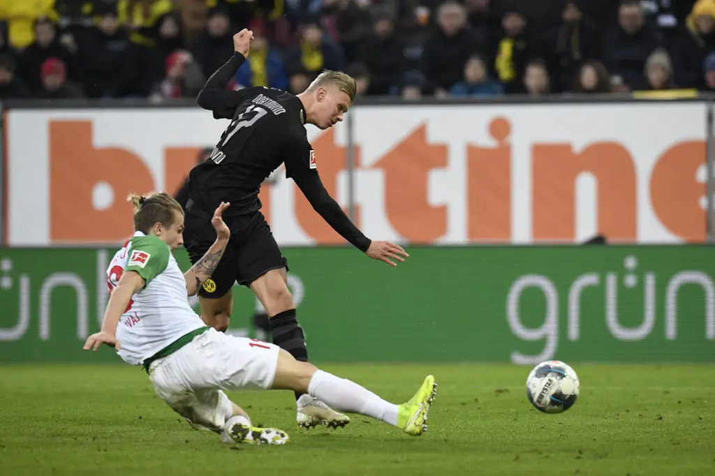 Dortmund's Norwegian forward Erling Braut Haaland (R) scores the 2-3 past Augsburg's Croatian defender Tin Jedvaj during the German first division Bundesliga football match Augsburg v Borussia Dortmund in Augsburg, on January 18, 2020. (Photo by THOMAS KIENZLE / AFP) / DFL REGULATIONS PROHIBIT ANY USE OF PHOTOGRAPHS AS IMAGE SEQUENCES AND/OR QUASI-VIDEO