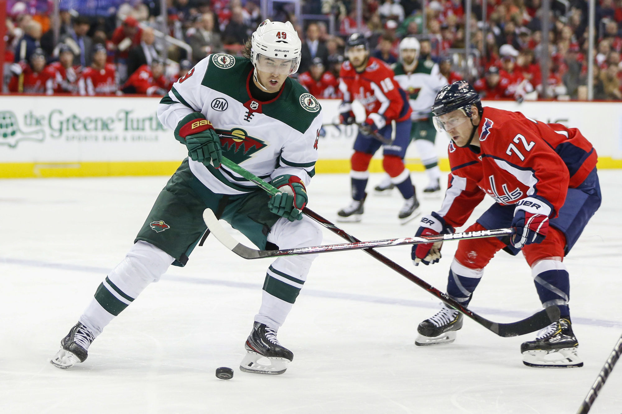 Mar 22, 2019; Washington, DC, USA; Minnesota Wild center Victor Rask (49) battles for the puck with Washington Capitals center Travis Boyd (72) during the second period at Capital One Arena. Photo : SUSA / Icon Sport