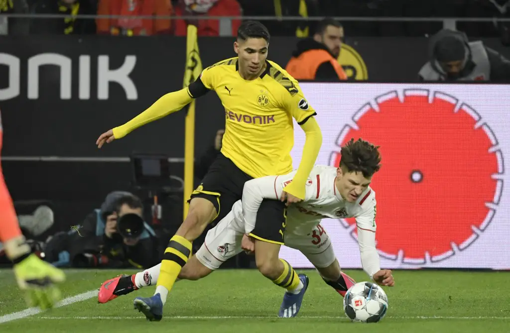 Dortmund's Moroccan defender Achraf Hakimi (L) and Cologne's Noah Katterbach vie with the ball during the German first division Bundesliga football match Borussia Dortmund v FC Cologne in Dortmund, on January 24, 2020. (Photo by Ina FASSBENDER / AFP) / DFL REGULATIONS PROHIBIT ANY USE OF PHOTOGRAPHS AS IMAGE SEQUENCES AND/OR QUASI-VIDEO