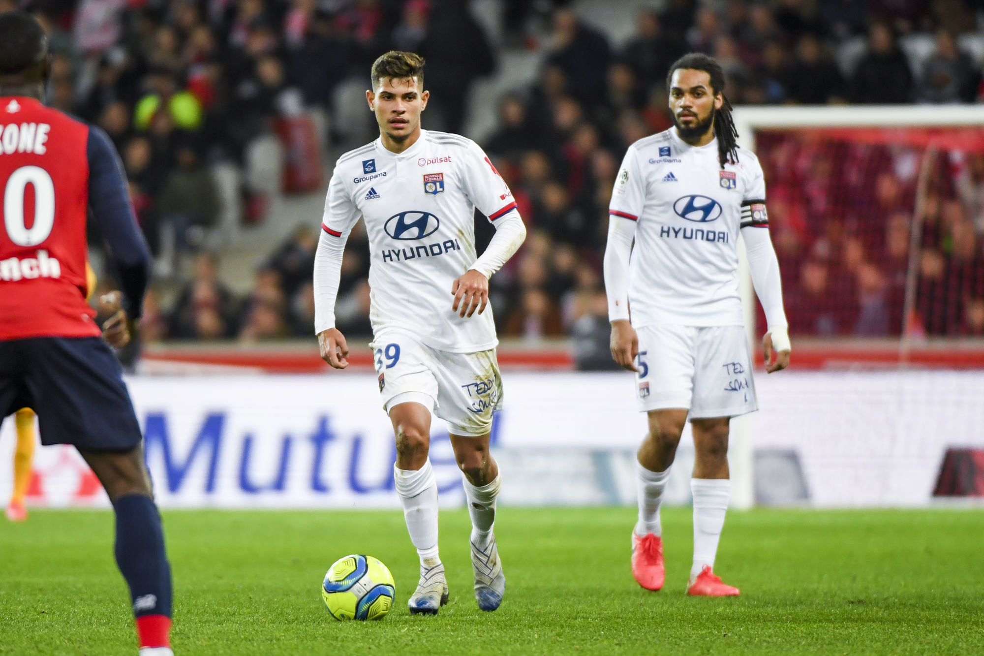 Bruno GUIMARAES of Olympique Lyonnais and Jason DENAYER of Olympique Lyonnais during the Ligue 1 match between Lille and Lyon at Stade Pierre-Mauroy on March 8, 2020 in Lille, France. (Photo by Aude Alcover/Icon Sport) - Bruno GUIMARAES - Jason DENAYER - Stade Pierre Mauroy - Lille (France)