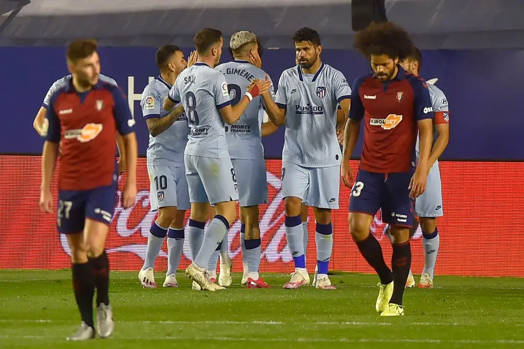 Atletico Madrid's players celebrate after Portuguese forward Joao Felix scored his team's second goal during the Spanish league football match CA Osasuna against Club Atletico de Madrid at El Sadar stadium in Pamplona on June 17, 2020. (Photo by ANDER GILLENEA / AFP)