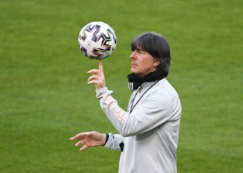 24 March 2021, North Rhine-Westphalia, Duisburg: Football: National team, final training National team before the World Cup qualifier against Iceland. German coach Joachim Löw holds the ball on his index finger.