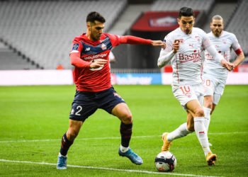 Zeki CELIK of Lille and Zinedine FERHAT of Nimes during the Ligue 1 match between Lille OSC and Nimes Olympique at Stade Pierre Mauroy on March 21, 2021 in Lille, France. (Photo by Matthieu Mirville/Icon Sport) - Stade Pierre Mauroy - Lille (France)