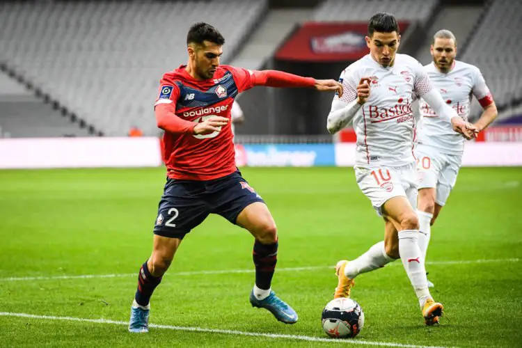 Zeki CELIK of Lille and Zinedine FERHAT of Nimes during the Ligue 1 match between Lille OSC and Nimes Olympique at Stade Pierre Mauroy on March 21, 2021 in Lille, France. (Photo by Matthieu Mirville/Icon Sport) - Stade Pierre Mauroy - Lille (France)