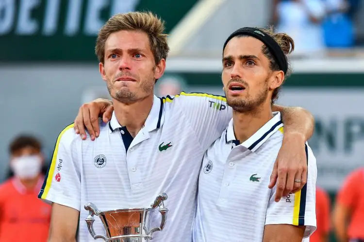 Nicolas MAHUT of France and Pierre Hugues HERBERT of France celebrate their victory with the trophy during the tenth round of Roland Garros at Roland Garros on June 12, 2021 in Paris, France. (Photo by Baptiste Fernandez/Icon Sport) - Nicolas MAHUT - Pierre Hugues HERBERT - Roland Garros - Paris (France)