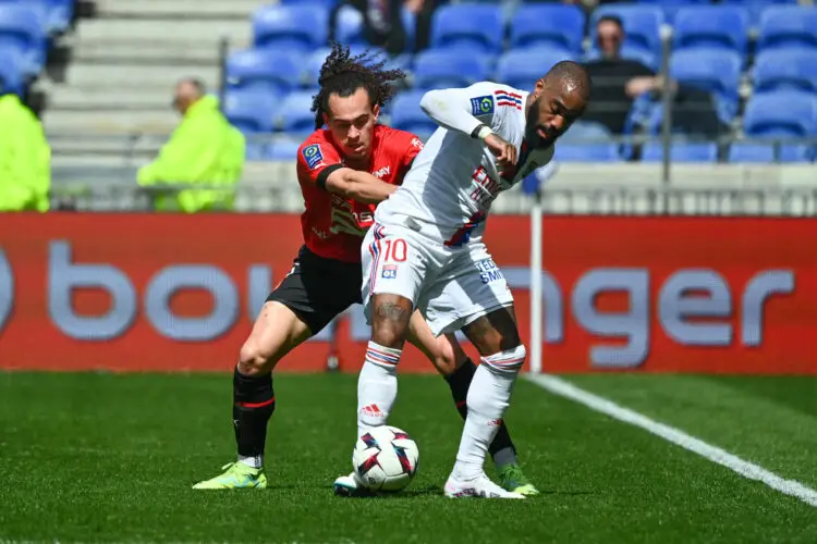 Arthur THEATE of Rennes and Alexandre LACAZETTE of Lyon during the Ligue 1 Uber Eats match between Lyon and Rennes at Groupama Stadium on April 9, 2023 in Lyon, France. (Photo by Anthony Dibon/Icon Sport)