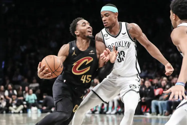 Mar 23, 2023; Brooklyn, New York, USA; Cleveland Cavaliers guard Donovan Mitchell (45) looks to drive past Brooklyn Nets center Nic Claxton (33) in the second quarter at Barclays Center. Mandatory Credit: Wendell Cruz-USA TODAY Sports/Sipa USA - Photo by Icon sport