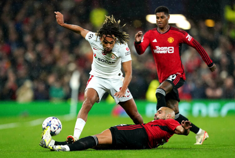 Manchester United's Sofyan Amrabat tackles Galatasaray's Sacha Boey during the UEFA Champions League Group A match at Old Trafford, Manchester. Picture date: Tuesday October 3, 2023. - Photo by Icon sport