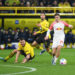 Niklas Suele (Borussia Dortmund) glisse face à Christoph Baumgartner (RB Leipzig) - Photo by Icon sport